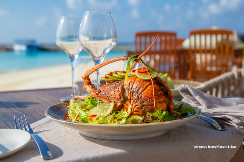 Dining at Veligandu Island Resort & Spa Hand-dived baked lobster served with lagoon views at Madivaru à la carte restaurant